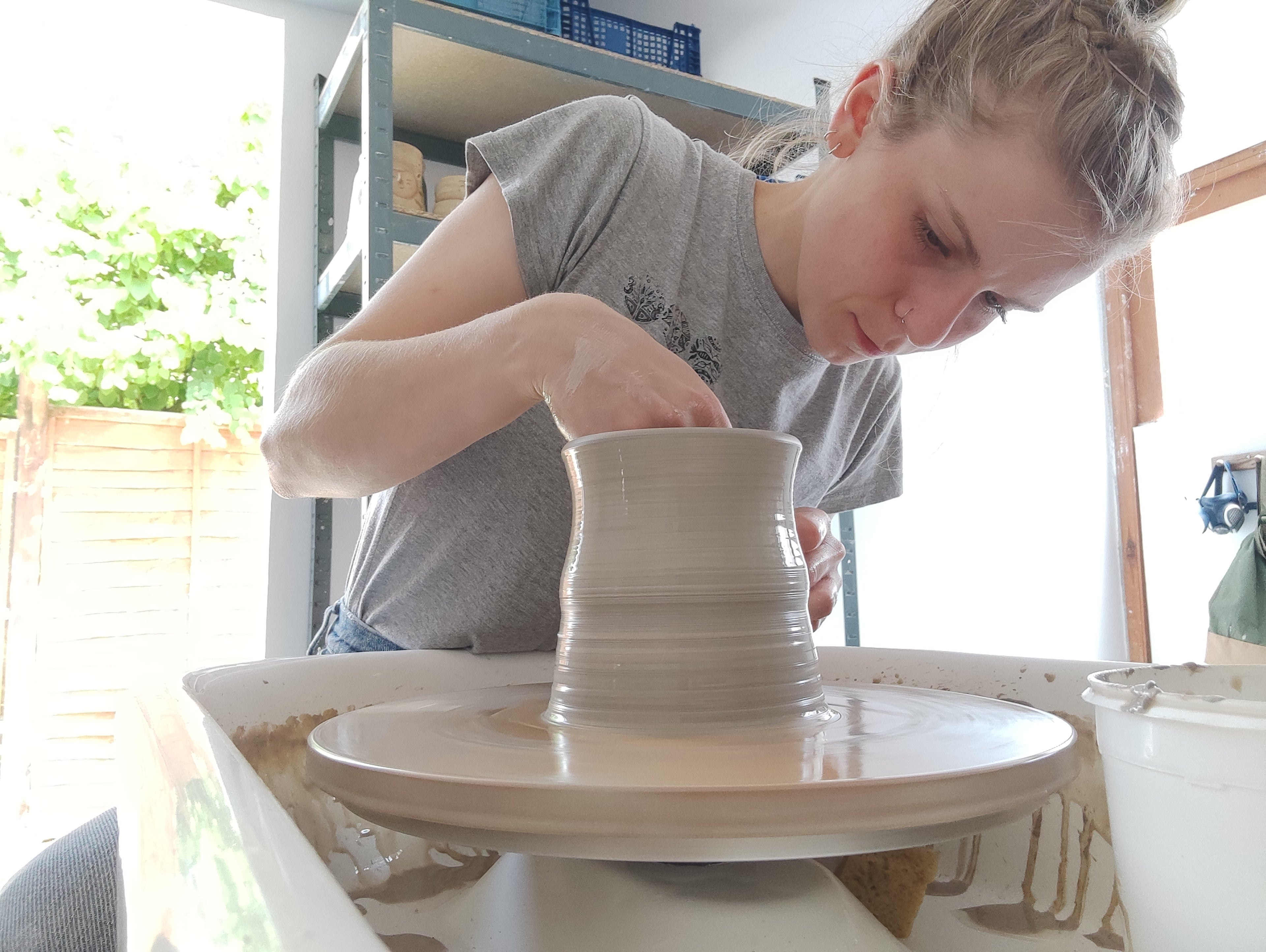 load video: shots of lizzie working away in her studio, and a few clips of her playing outside with her two dogs.
